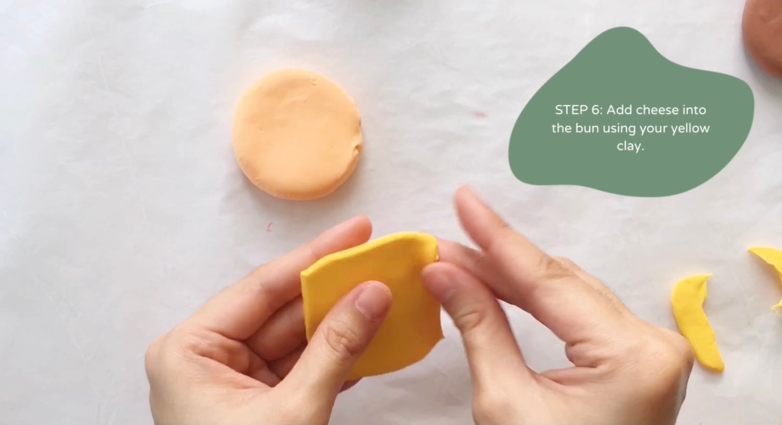 Step 6 of the DIY clay burger tutorial: Add cheese into the bun using your yellow clay.