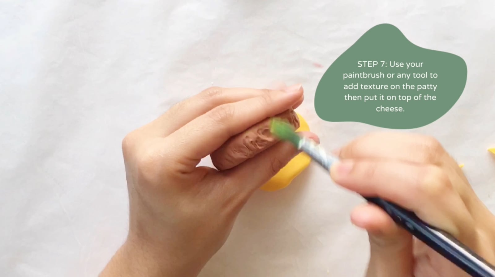 Step 7 of the DIY clay burger tutorial: Use your paintbrush or any tool to add texture on the patty then put it on top of the cheese.