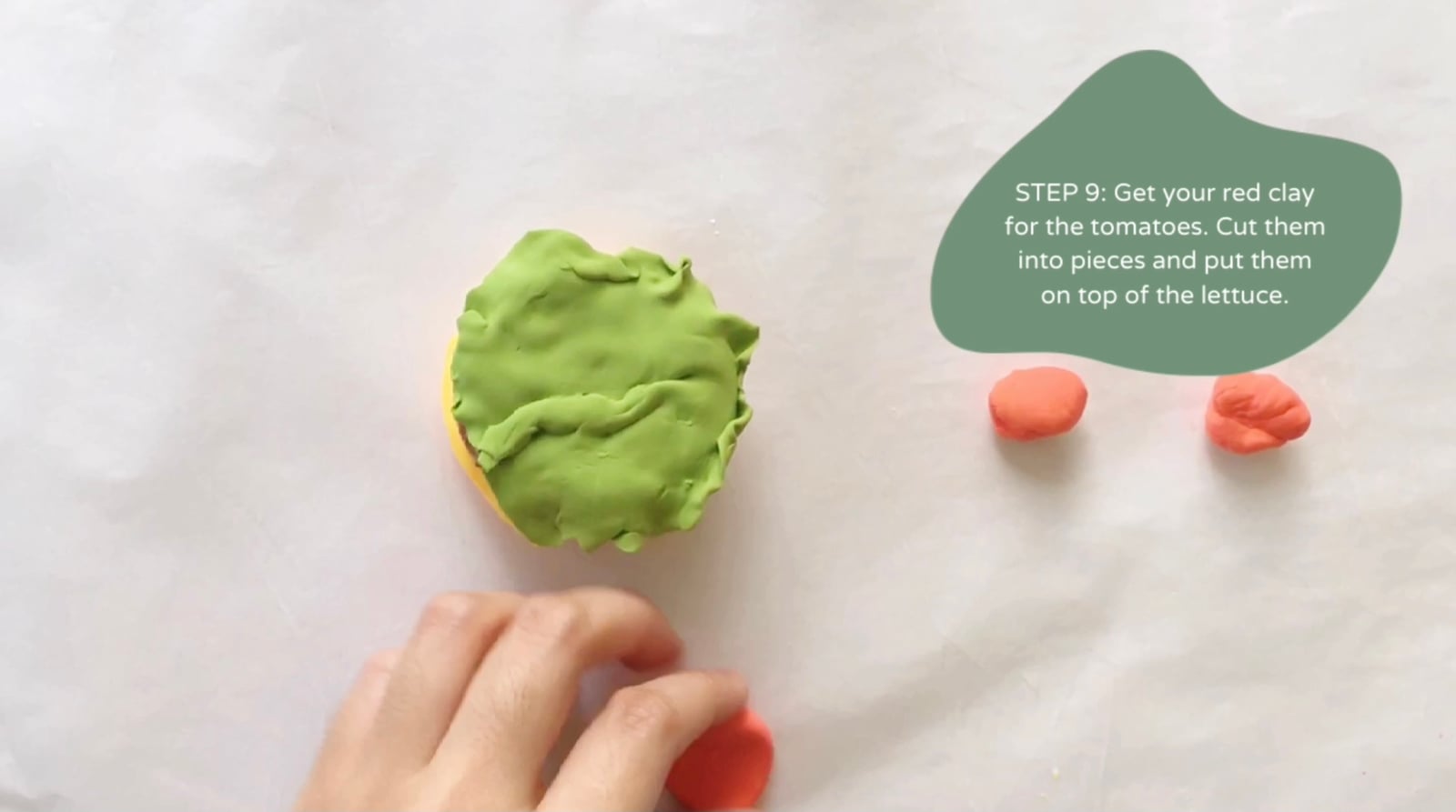 Step 9 of the DIY clay burger tutorial: Get your red clay for the tomatoes. Cut them into pieces and put them on top of the lettuce.