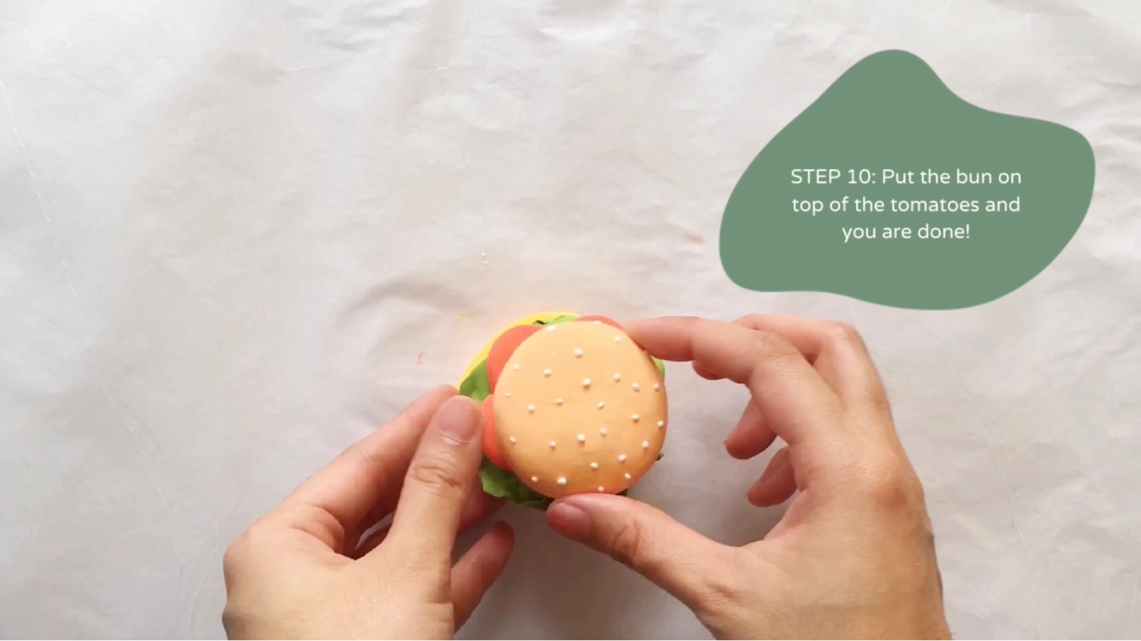 Step 10 of the DIY clay burger tutorial: Put the bun on top of the tomatoes and you are done.