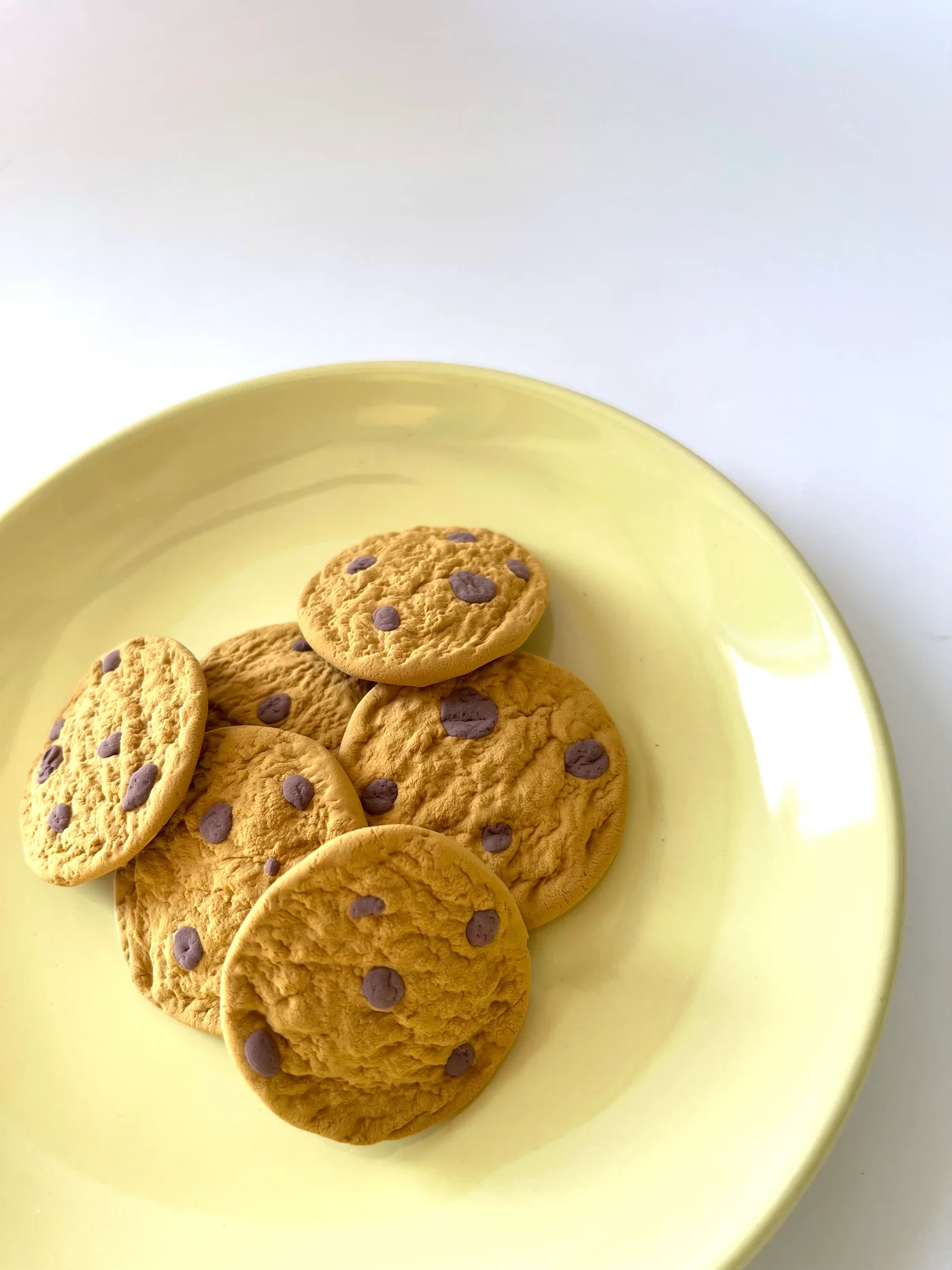 Air-dry clay chocolate chip cookies with stippled texture and pressed-in chips