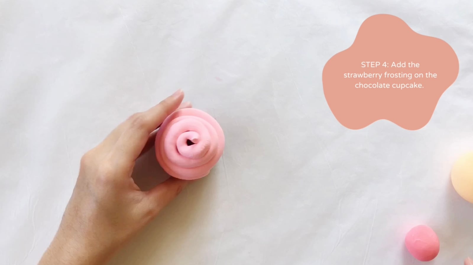Step 4 of the DIY clay cupcakes tutorial: Add the strawberry frosting on the chocolate cupcake.