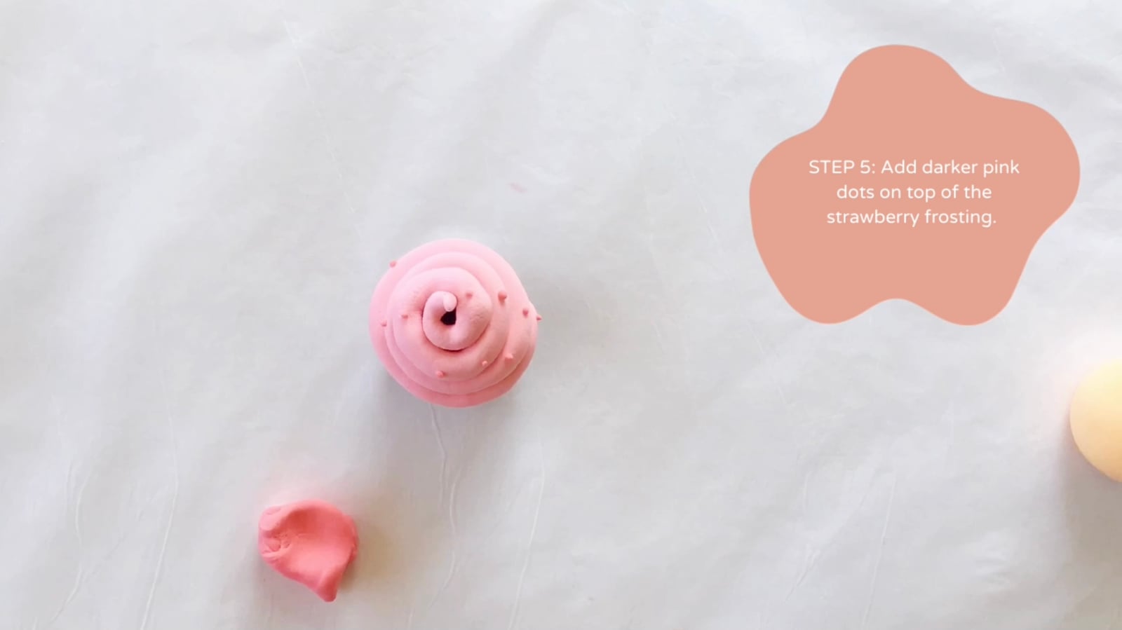 Step 5 of the DIY clay cupcakes tutorial: Add darker pink dots on top of the strawberry frosting.