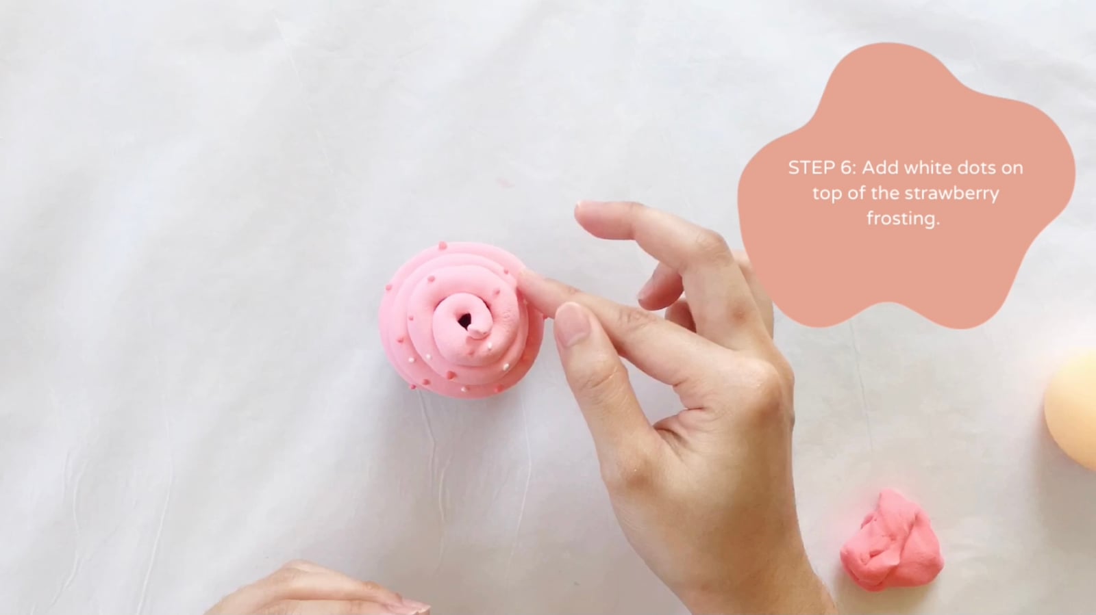 Step 6 of the DIY clay cupcakes tutorial: Add white dots on top of the strawberry frosting.