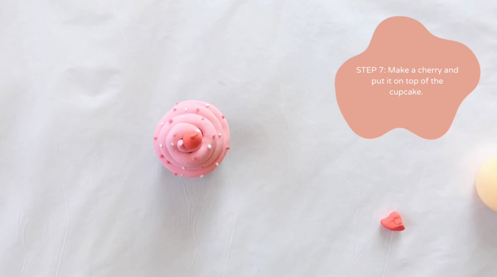 Step 7 of the DIY clay cupcakes tutorial: Make a cherry and put it on top of the cupcake.