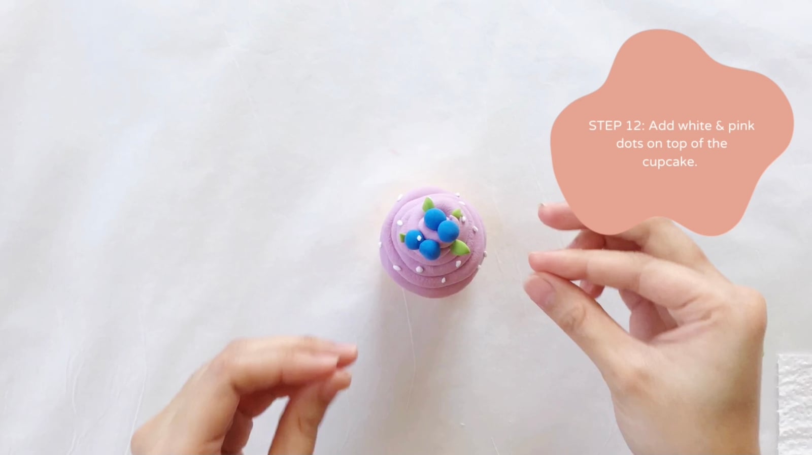 Step 12 of the DIY clay cupcakes tutorial: Add white and pink dots on top of the cupcake.