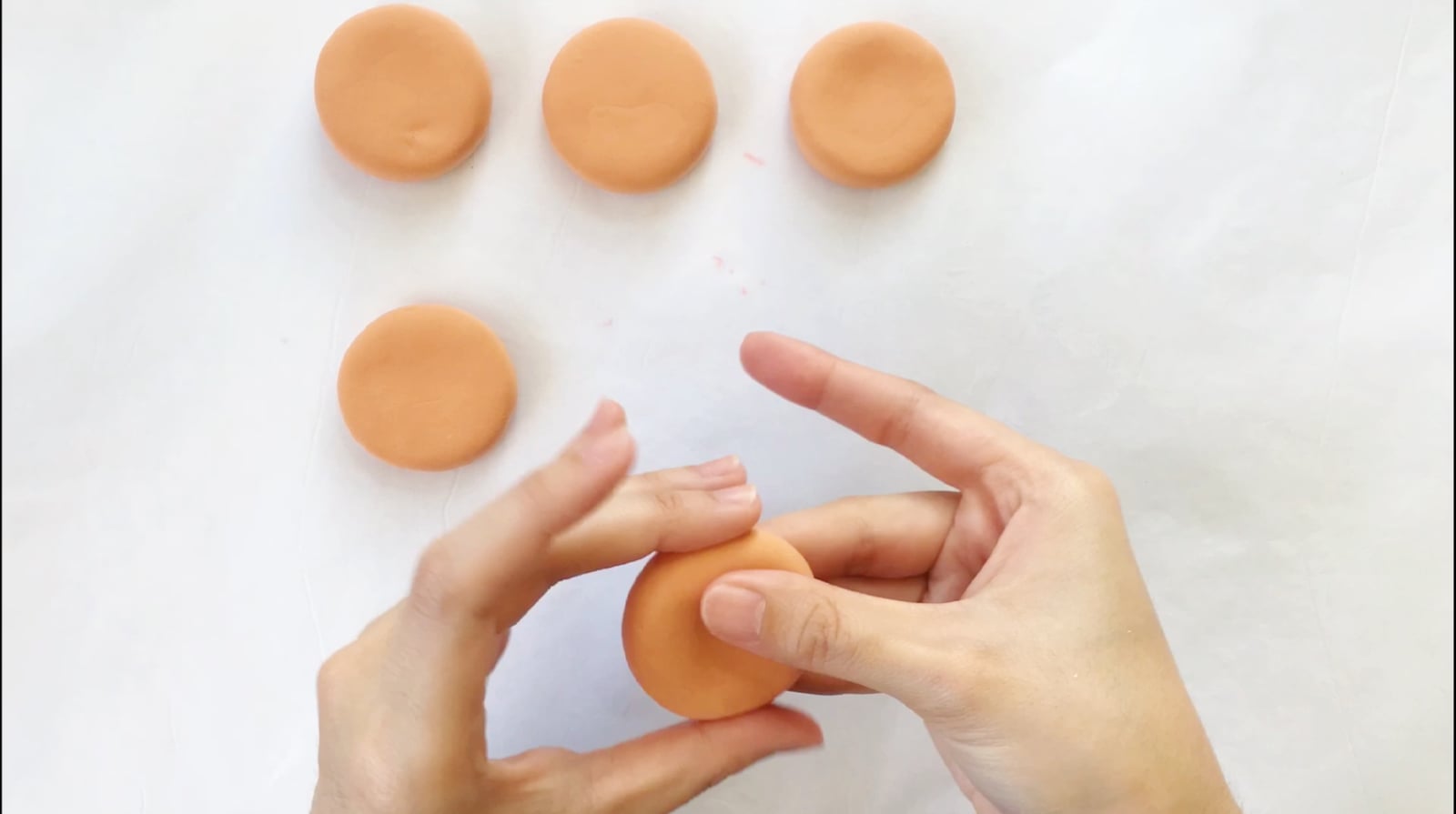Step 2 of the DIY clay donuts tutorial: Mold a circular shape for the doughnuts.