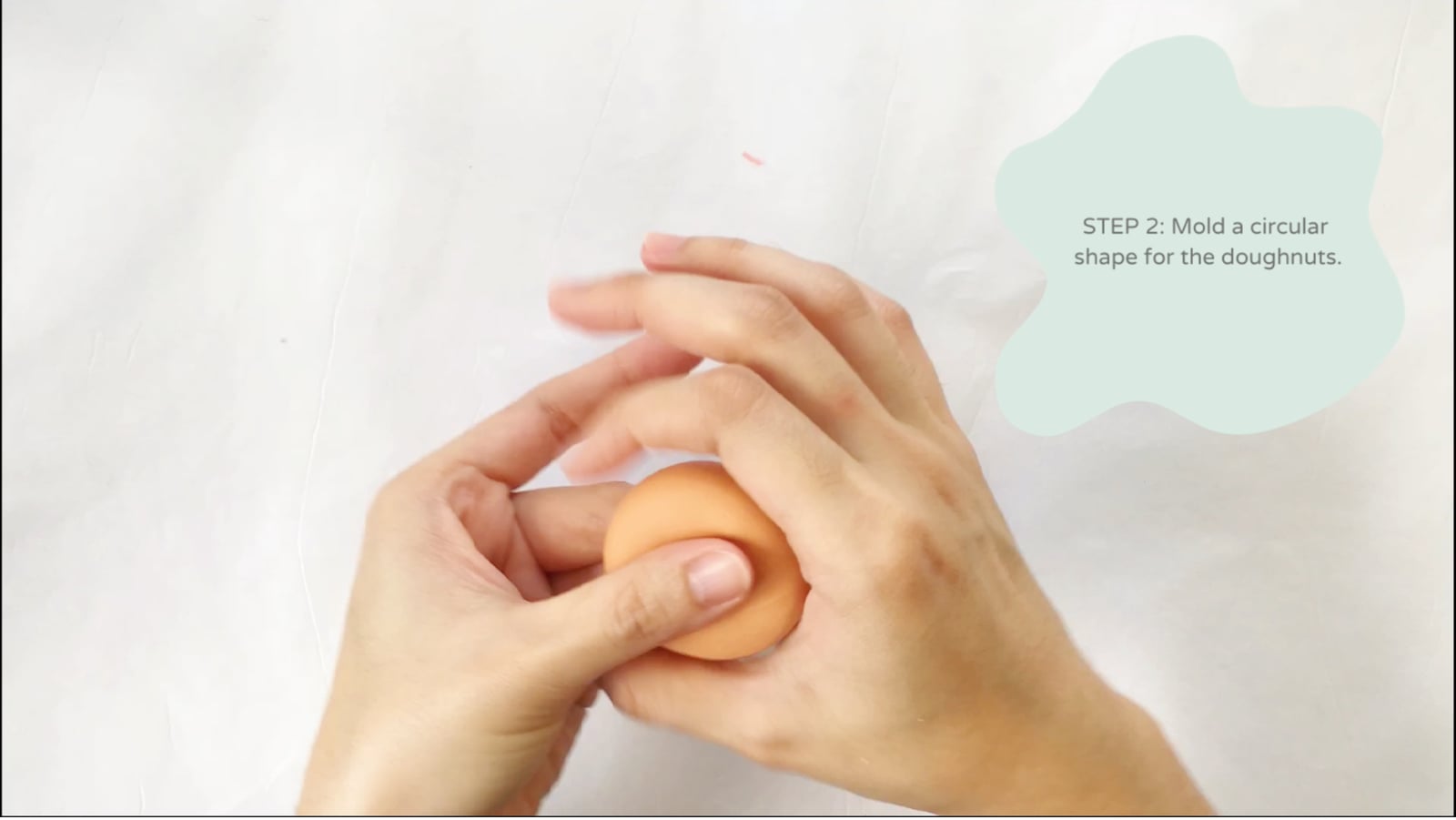 Step 2 of the DIY clay donuts tutorial: Mold a circular shape for the doughnuts.