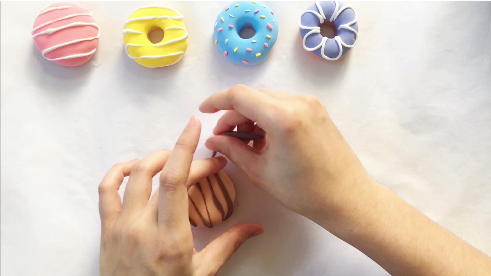 Step 7 of the DIY clay donuts tutorial: Add chocolate frosting.