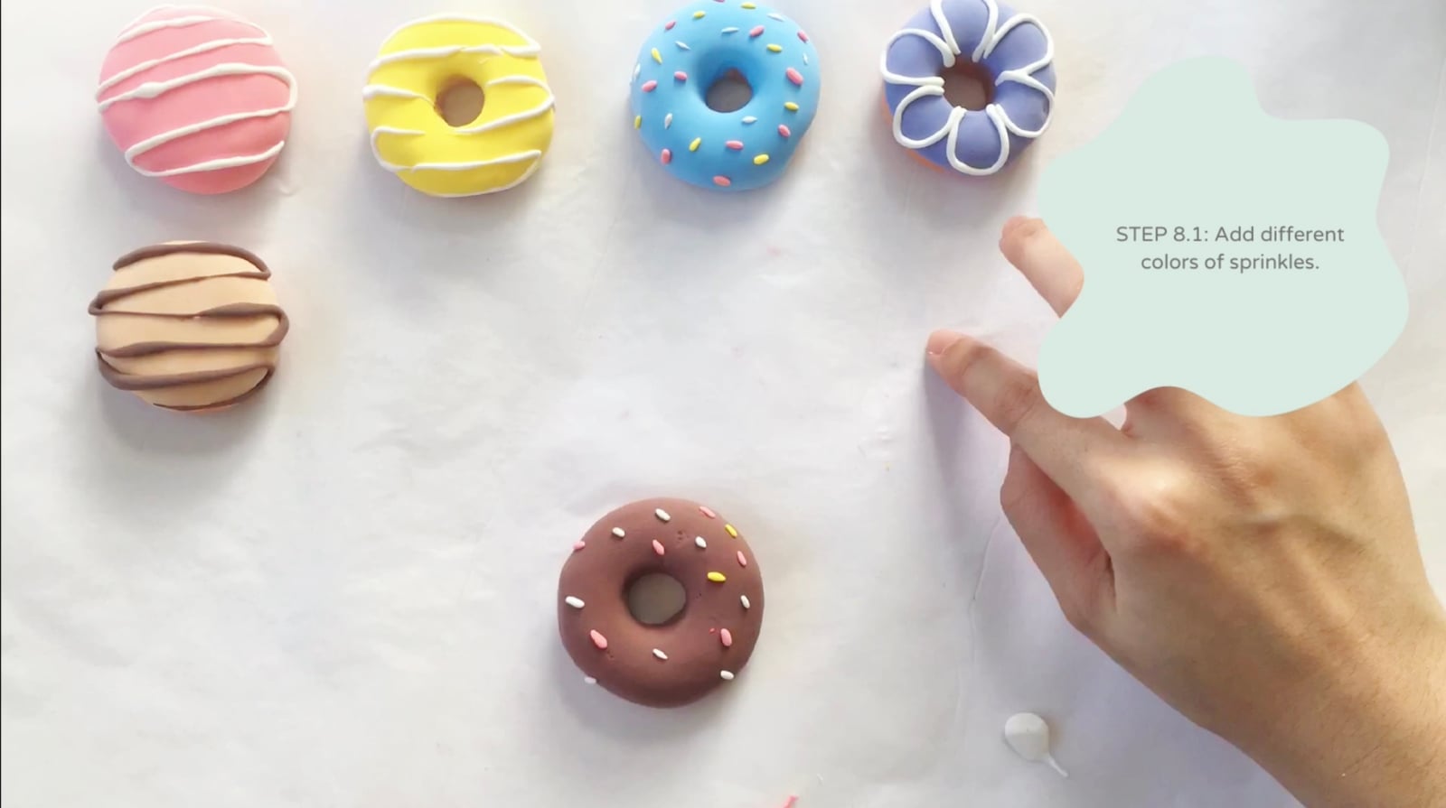 Step 8 of the DIY clay donuts tutorial: Add different colors of sprinkles.