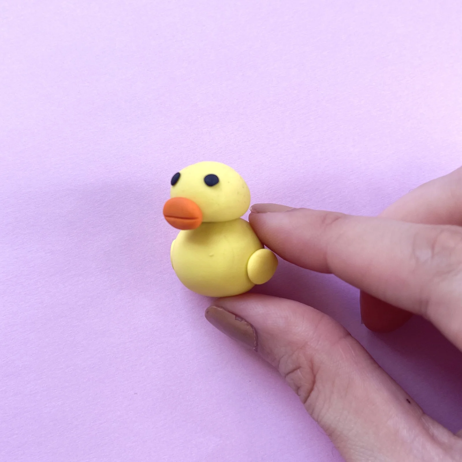 Step 5 of the mini clay animal erasers tutorial: knead the beak and attach it