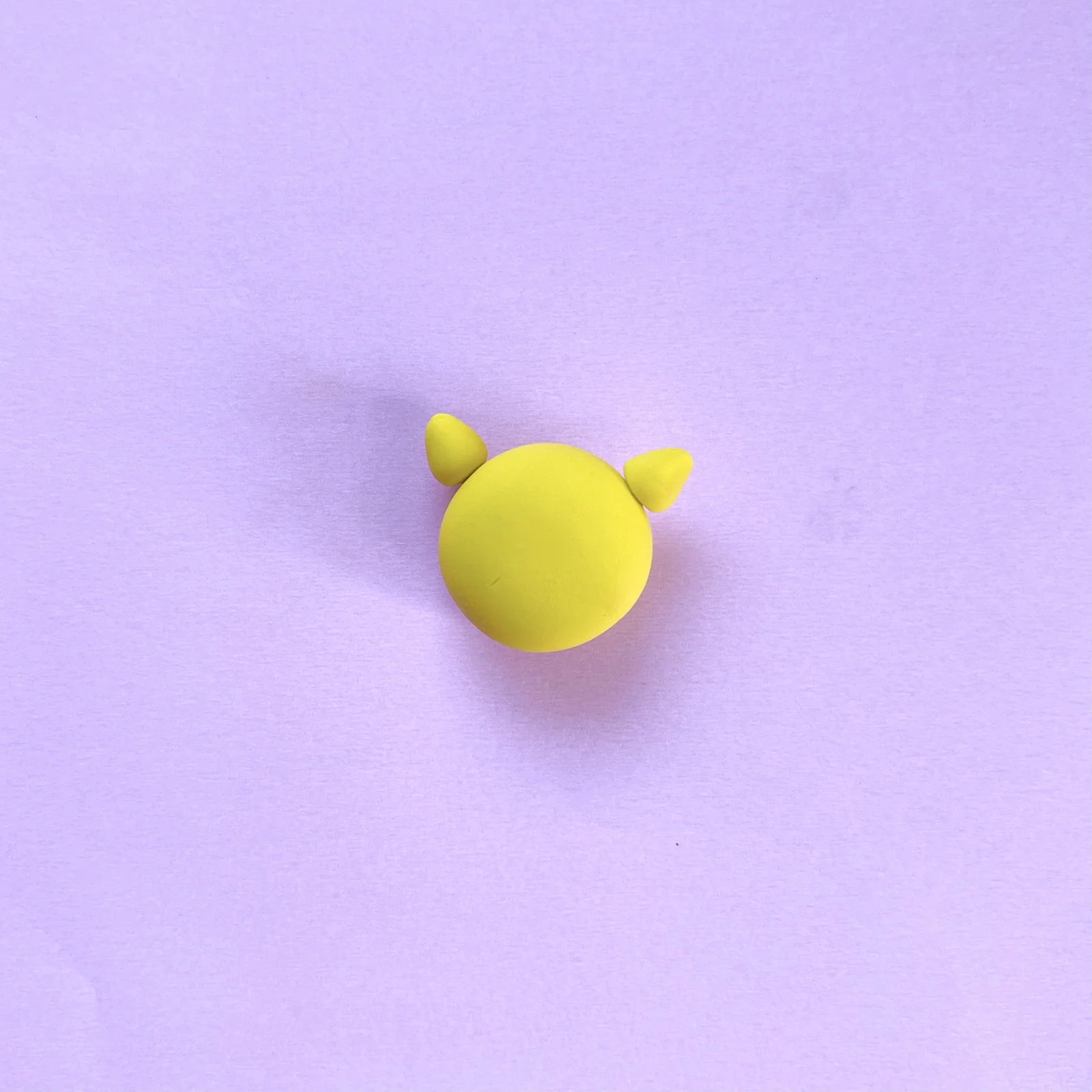 Step 2 of the mini clay animal erasers tutorial: make cone ears and attach them