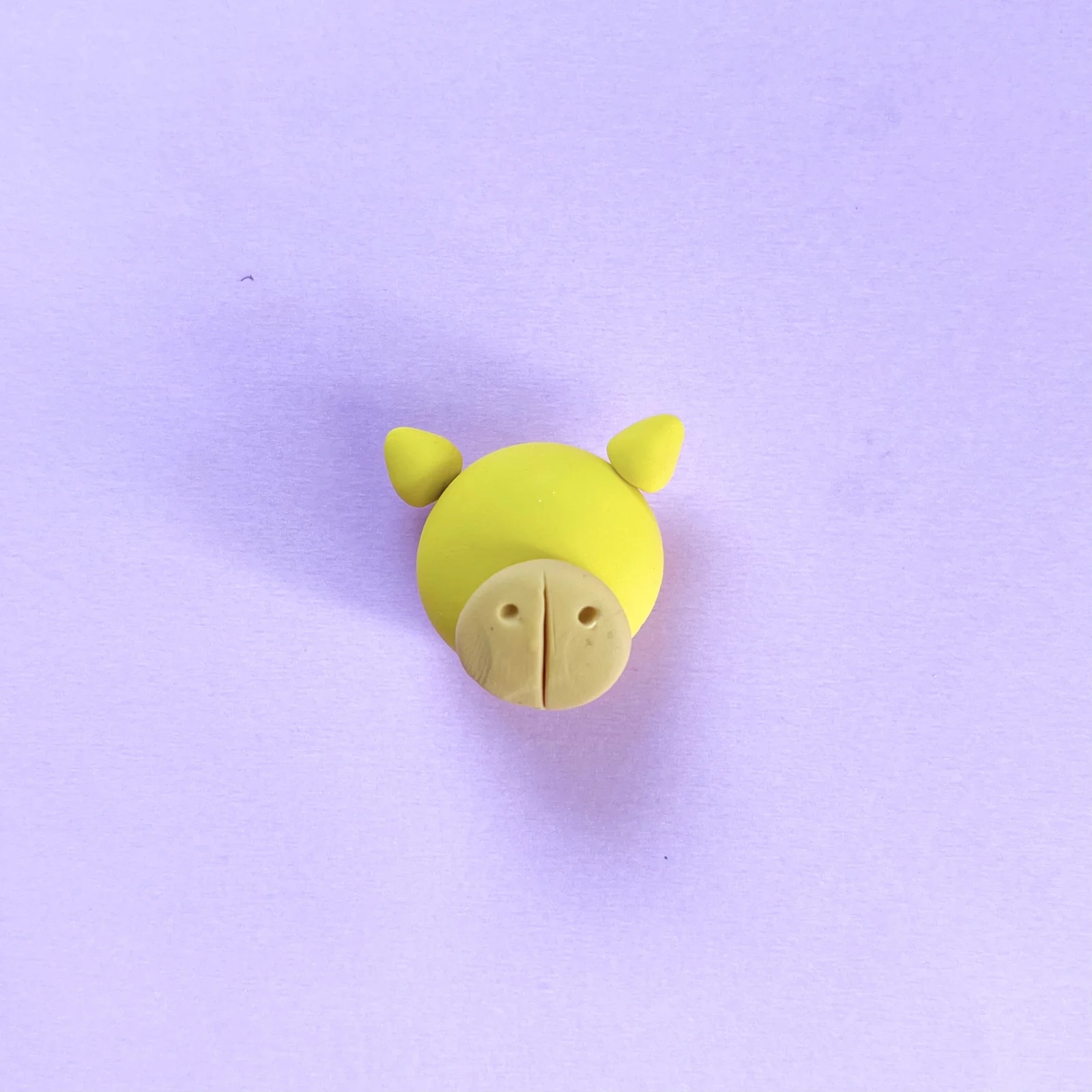 Step 4 of the mini clay animal erasers tutorial: add a line in the mouth and two nose holes