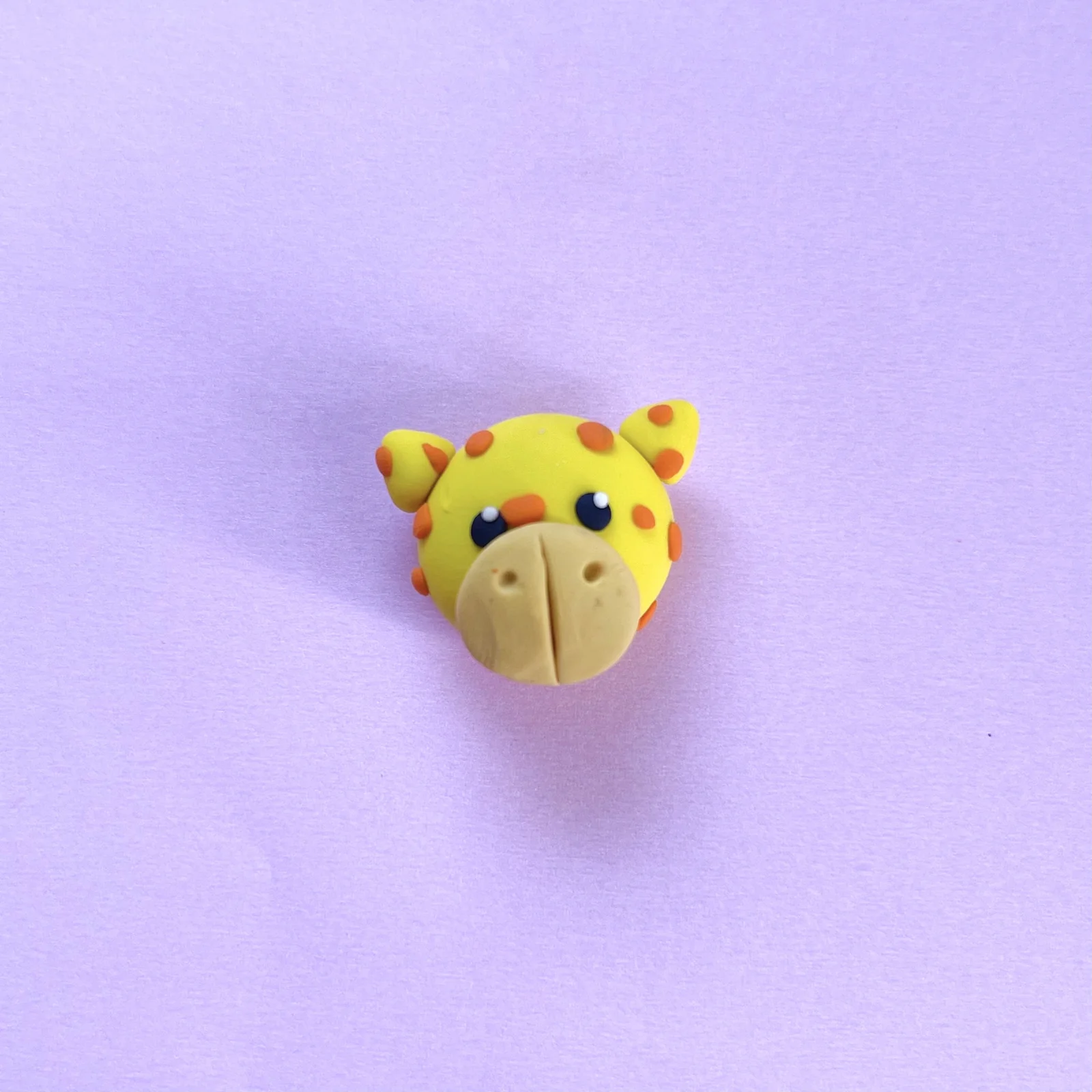 Step 6 of the mini clay animal erasers tutorial: roll and flatten the eyes
