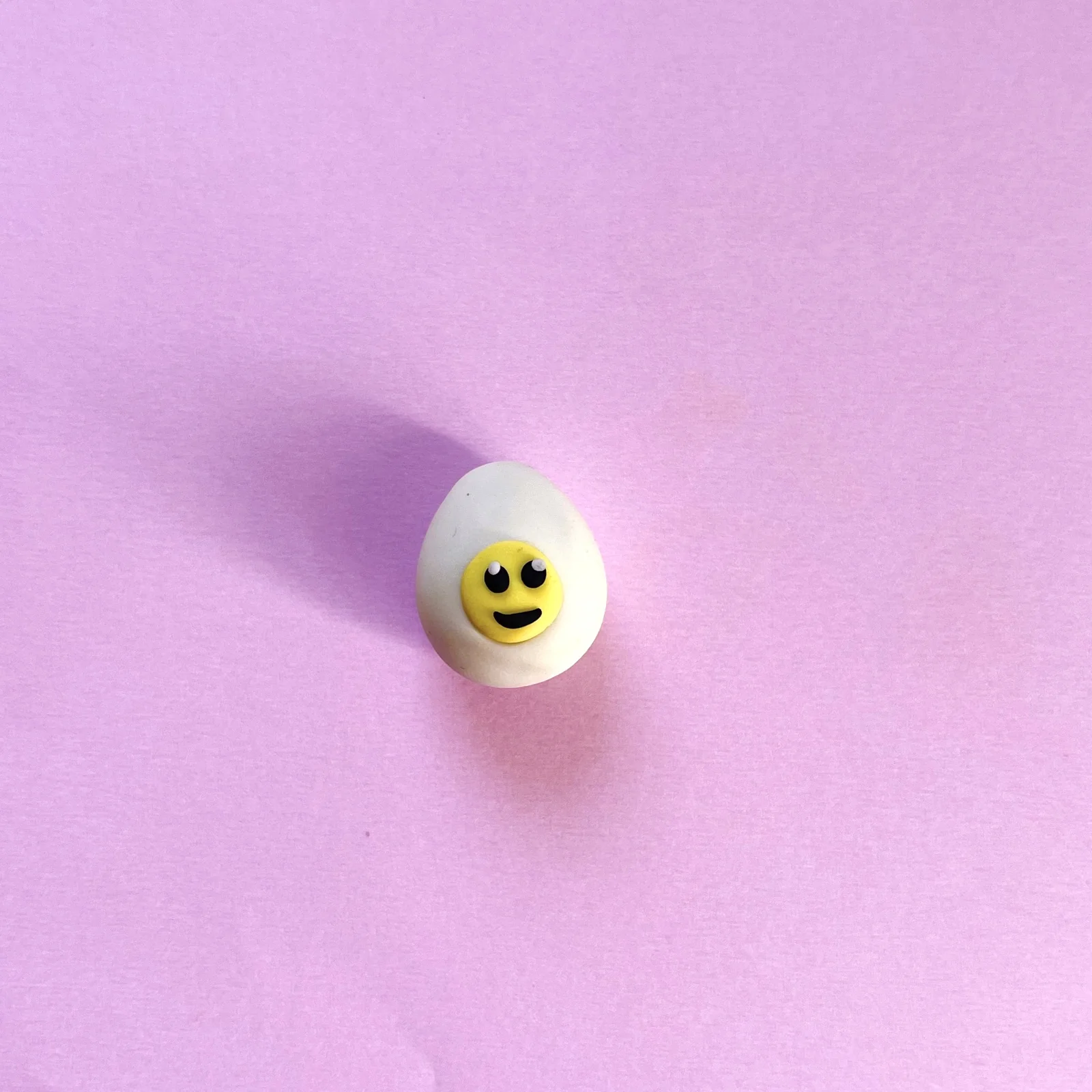 The finished fried egg eraser with a smiling yellow yolk face
