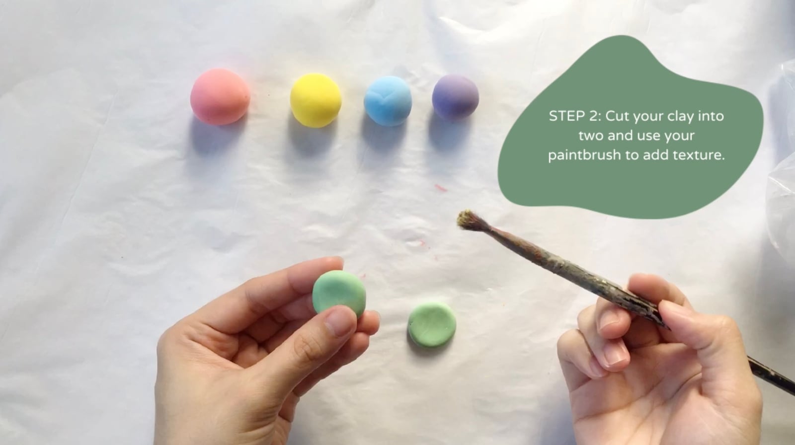 Step 2 of the DIY clay macarons tutorial: Cut your clay into two and use your paintbrush to add texture.