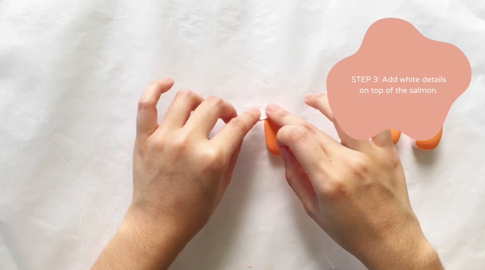 Step 3 of the DIY clay sushi tutorial: Add white details on top of the salmon.