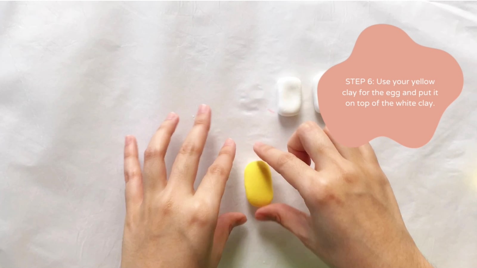 Step 6 of the DIY clay sushi tutorial: Use your yellow clay for the egg and put it on top of the white clay.