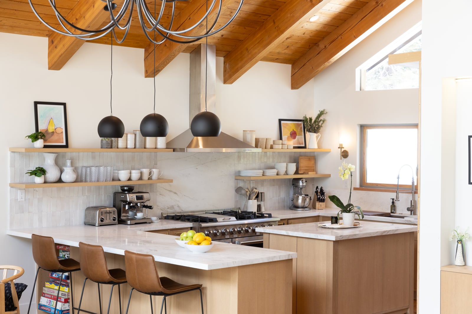 After: renovated kitchen range wall, Calacatta marble slab backsplash, hood and open shelving on both sides